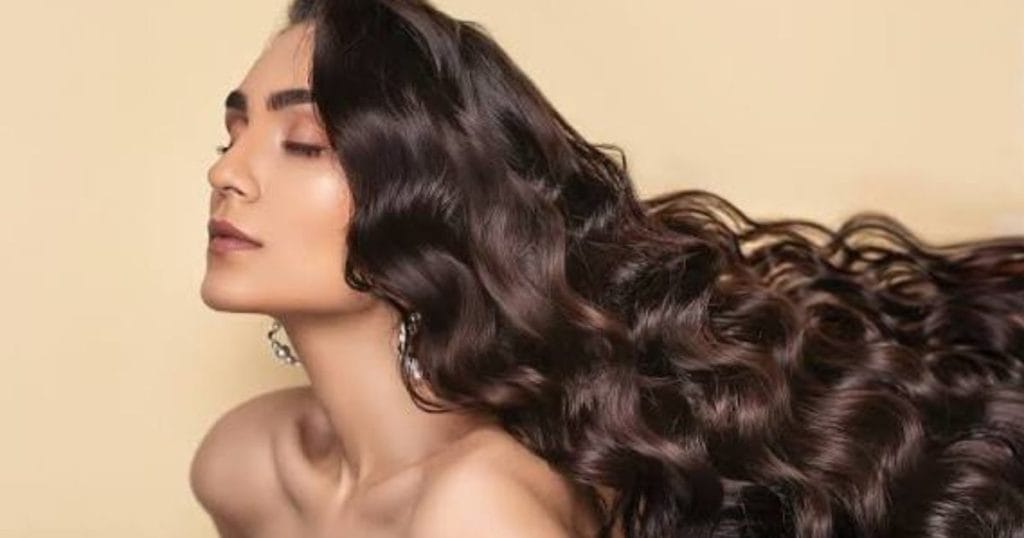 Woman with long healthy shining hairs with Oil