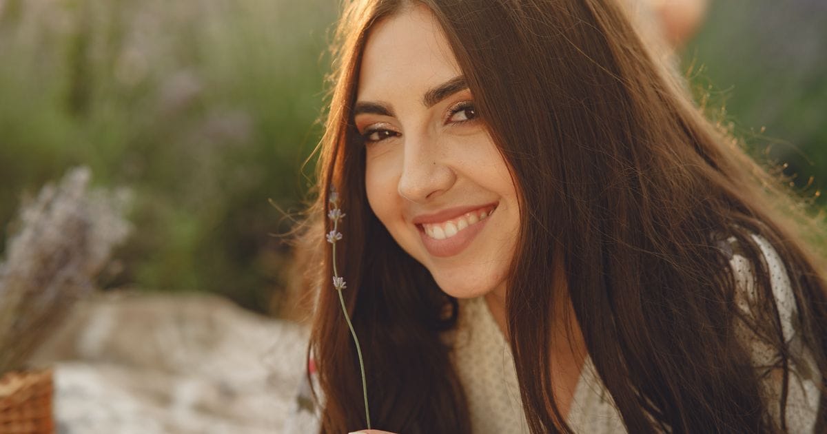 Woman with healthy shiny hair smiling